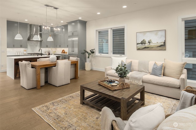 living room with sink and light hardwood / wood-style flooring