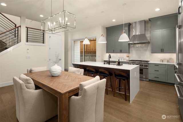 dining space with sink, dark hardwood / wood-style floors, and an inviting chandelier