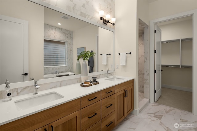 bathroom featuring vanity and independent shower and bath