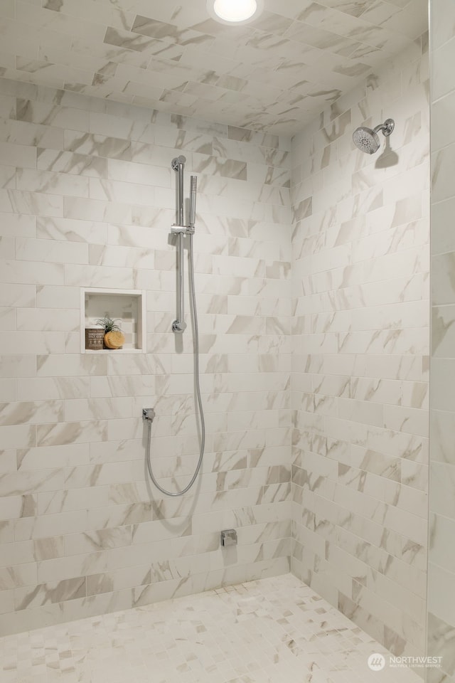 bathroom with tiled shower