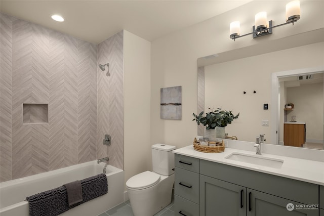 full bathroom featuring tile patterned flooring, vanity, toilet, and tiled shower / bath