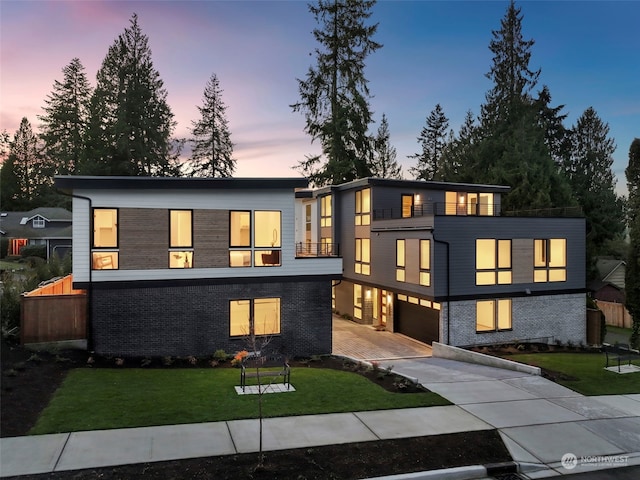 modern home featuring a lawn and a garage