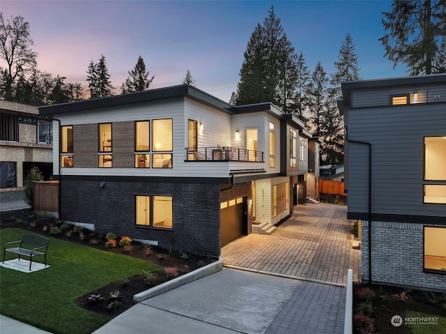 contemporary house with a yard and a garage