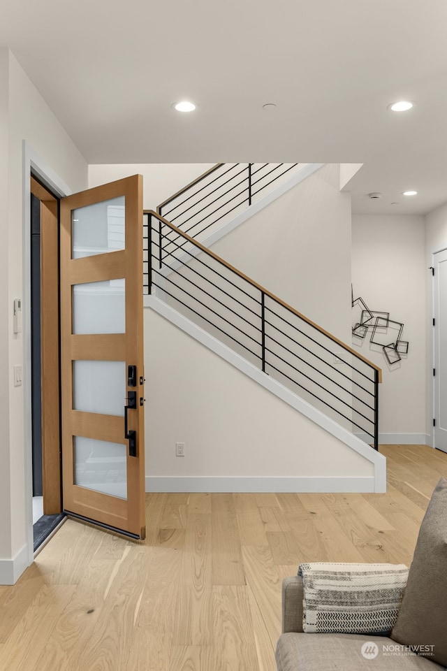 foyer entrance with hardwood / wood-style flooring