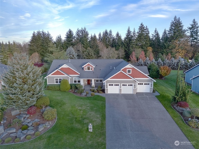 view of front of home with a front yard and a garage