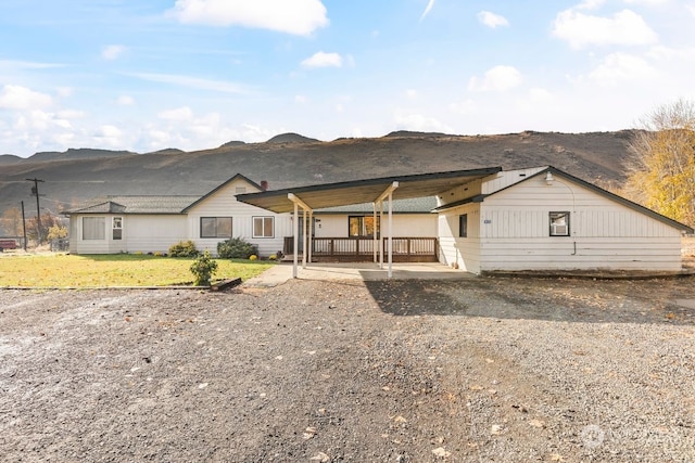 view of front facade with a mountain view and a front lawn