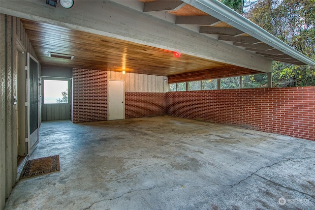 exterior space with brick wall and concrete floors