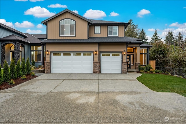 view of front of property with a garage and a front yard