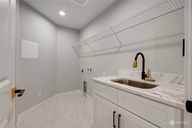 clothes washing area with hookup for an electric dryer, cabinets, sink, and hookup for a washing machine