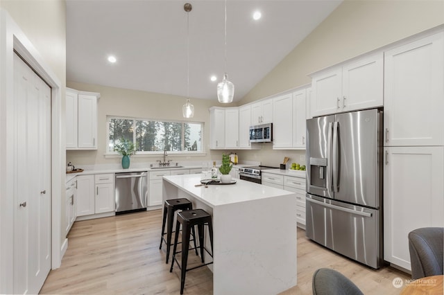 kitchen with white cabinetry, sink, a center island, and appliances with stainless steel finishes