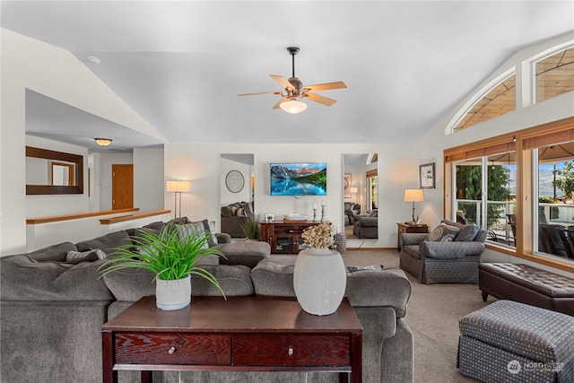 carpeted living room featuring ceiling fan and vaulted ceiling