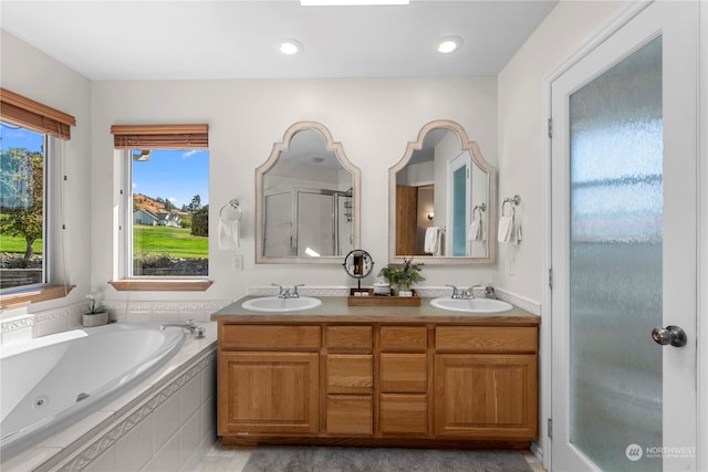 bathroom featuring shower with separate bathtub, vanity, and plenty of natural light