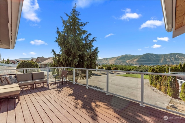 wooden deck featuring outdoor lounge area and a mountain view