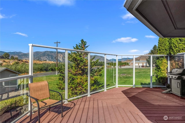 exterior space with a mountain view and grilling area