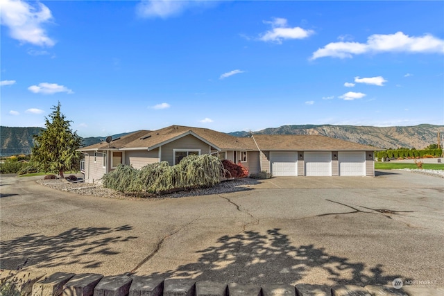 ranch-style home featuring a mountain view and a garage