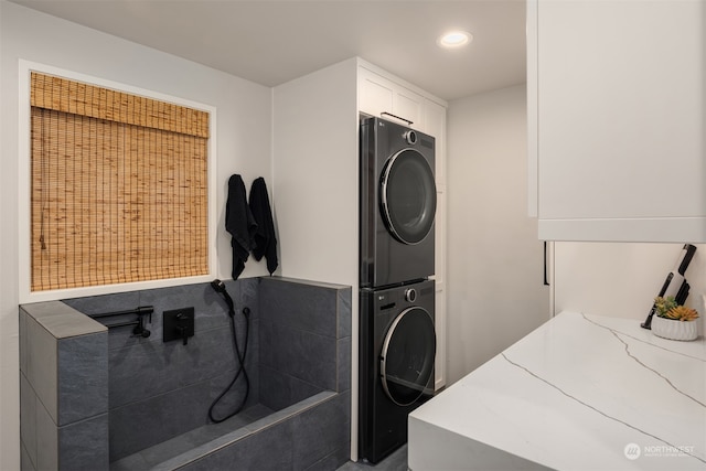 laundry room featuring stacked washer and clothes dryer