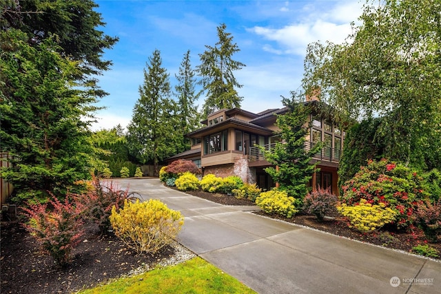 7842 NE 10th St, Medina, WA 98039 - view of front of house with concrete driveway and a chimney