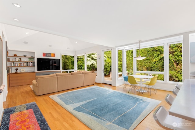 sunroom with a healthy amount of sunlight and lofted ceiling