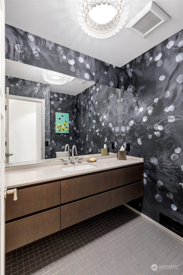 bathroom with tile patterned flooring, vanity, and a chandelier