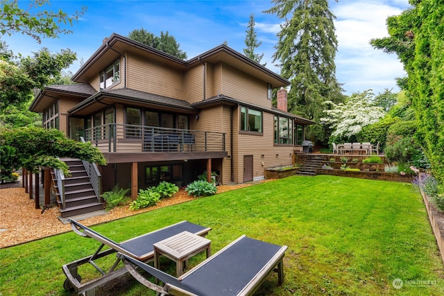 back of house featuring a yard and a deck