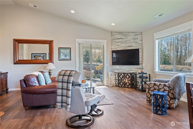 146 Zephyr Dr, Silverlake, WA 98645 - living room featuring vaulted ceiling, wood finished floors, plenty of natural light, a stone fireplace, and recessed lighting
