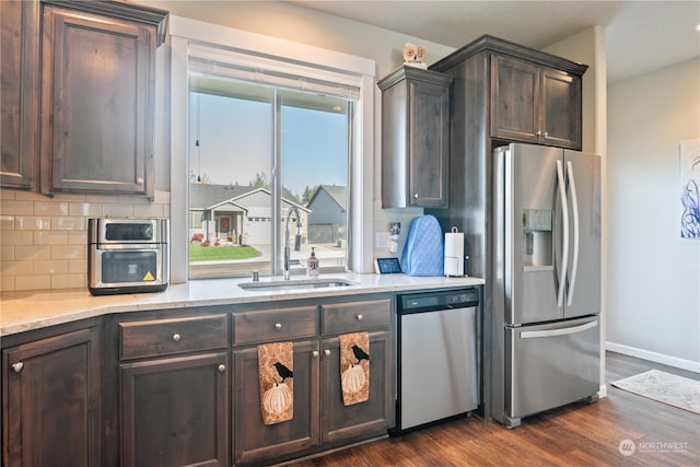 146 Zephyr Dr, Silverlake, WA 98645 - kitchen featuring appliances with stainless steel finishes, dark wood finished floors, dark brown cabinets, and backsplash