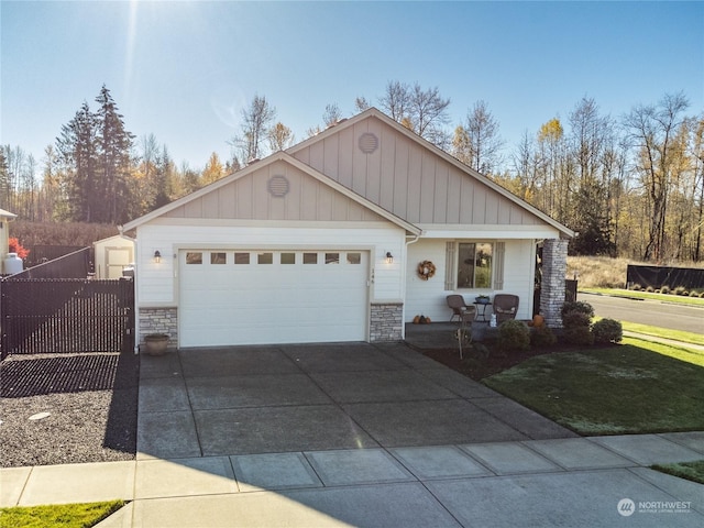 146 Zephyr Dr, Silverlake, WA 98645 - ranch-style home featuring stone siding, a garage, concrete driveway, and board and batten siding