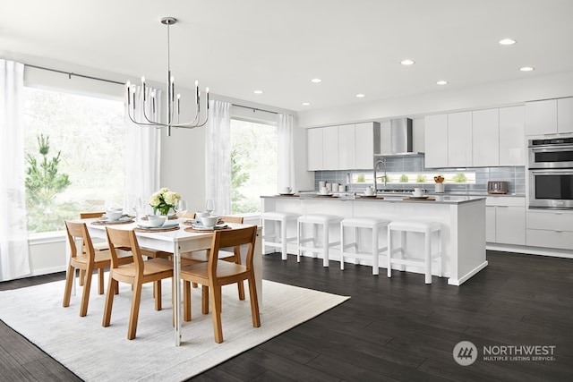 dining room featuring a chandelier and dark hardwood / wood-style floors