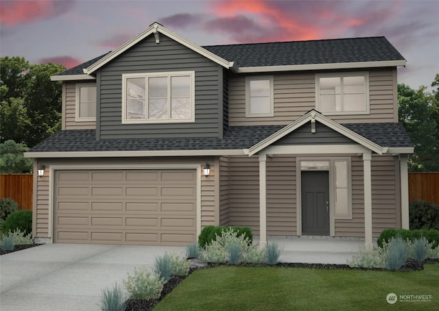 view of front of house with a yard and a garage