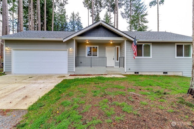 ranch-style house featuring a porch, a garage, and a front yard