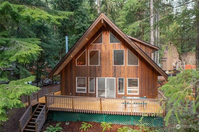 rear view of property featuring a deck