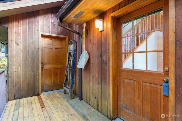 interior space featuring wood walls and light hardwood / wood-style flooring