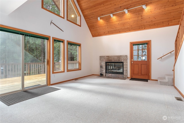 unfurnished living room featuring carpet floors, track lighting, high vaulted ceiling, and a healthy amount of sunlight