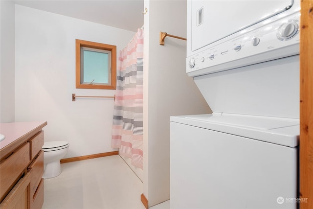 washroom featuring stacked washer / dryer