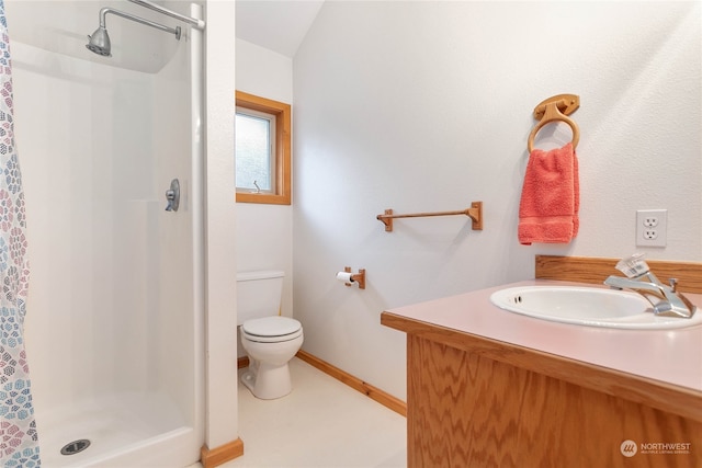 bathroom with a shower, vanity, and toilet