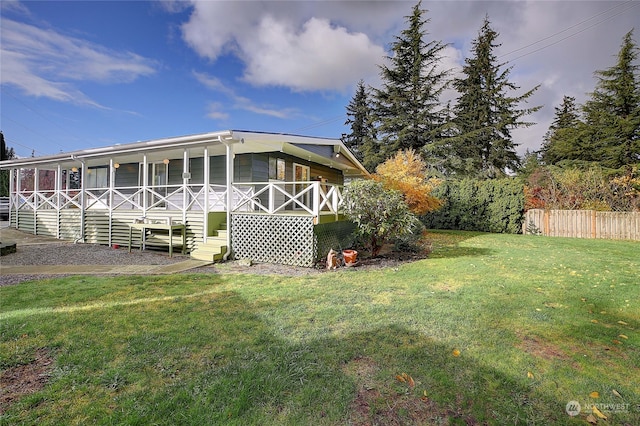 rear view of house with a yard and covered porch