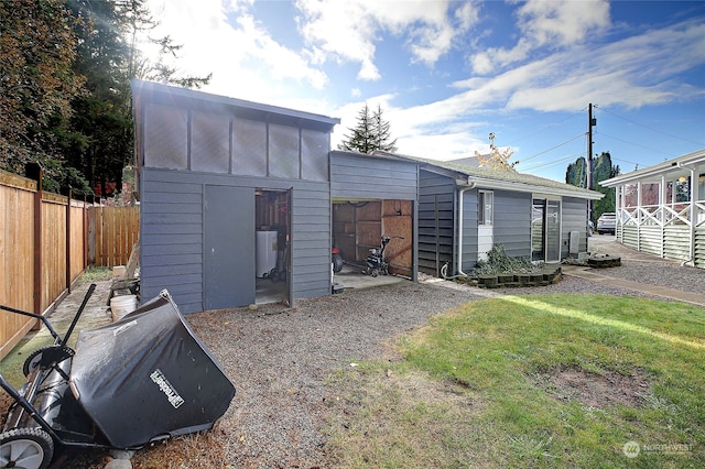 view of outbuilding featuring a lawn