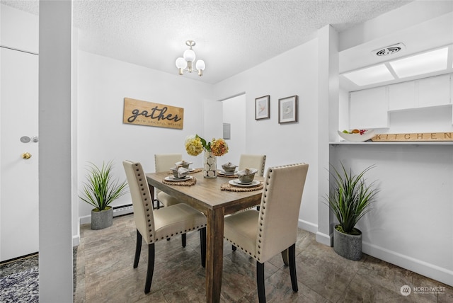 dining area with a textured ceiling, a baseboard radiator, and a chandelier