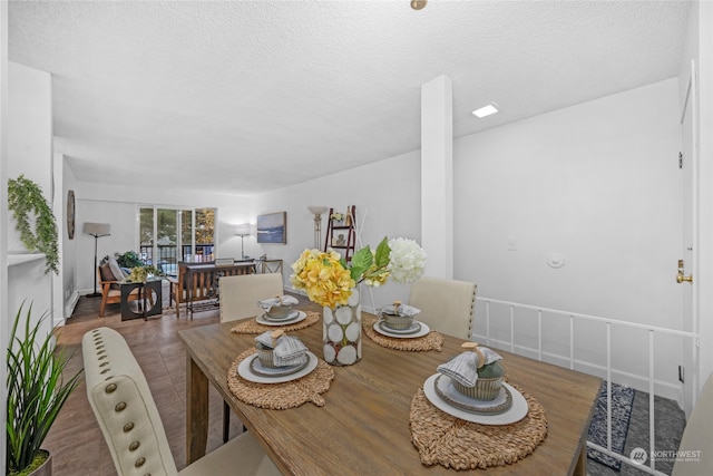 dining area featuring hardwood / wood-style floors and a textured ceiling