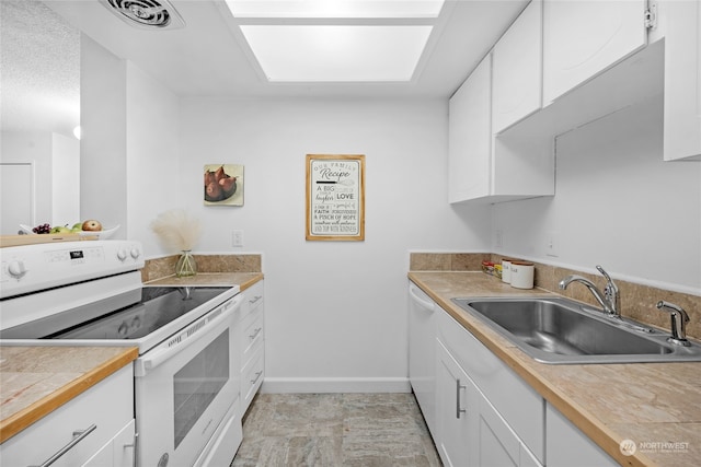 kitchen with white cabinets, white appliances, and sink