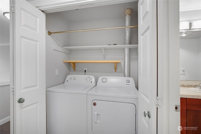 laundry room with separate washer and dryer and sink