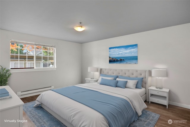 bedroom featuring dark hardwood / wood-style flooring and a baseboard heating unit