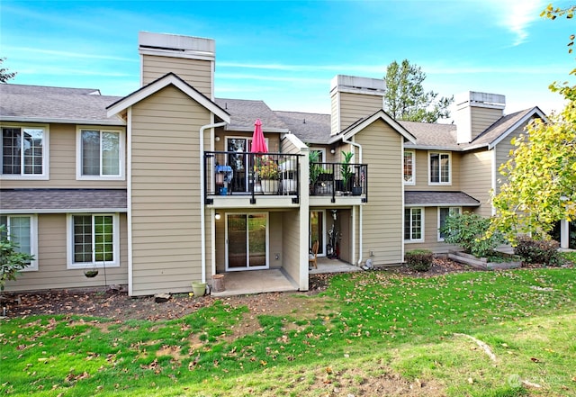 back of property featuring a patio and a lawn