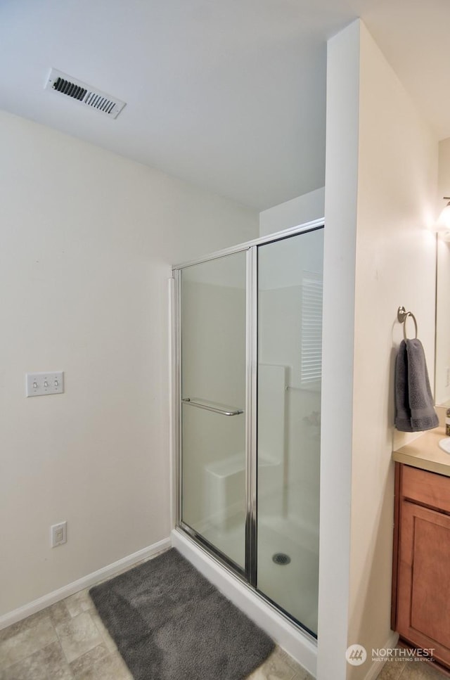 bathroom featuring vanity and an enclosed shower