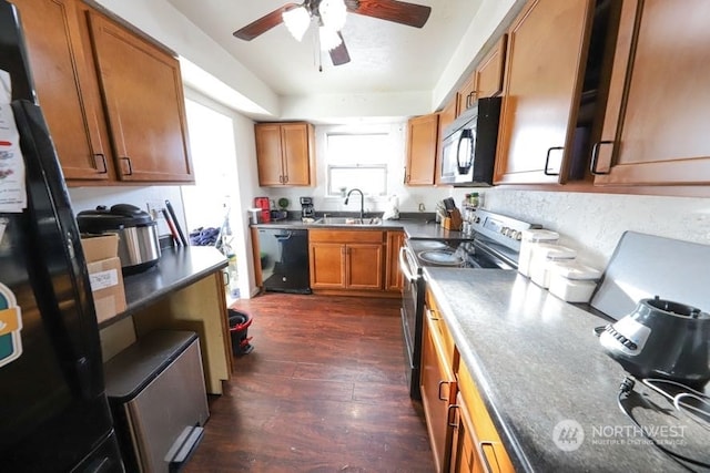 kitchen with ceiling fan, dark wood-type flooring, black appliances, and sink