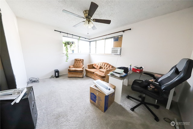 interior space featuring ceiling fan, carpet floors, and a textured ceiling