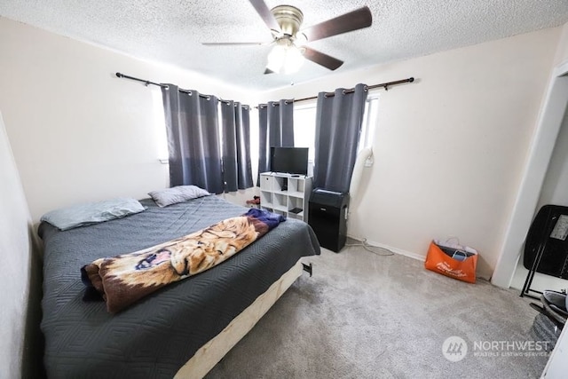 bedroom featuring carpet flooring, a textured ceiling, and ceiling fan