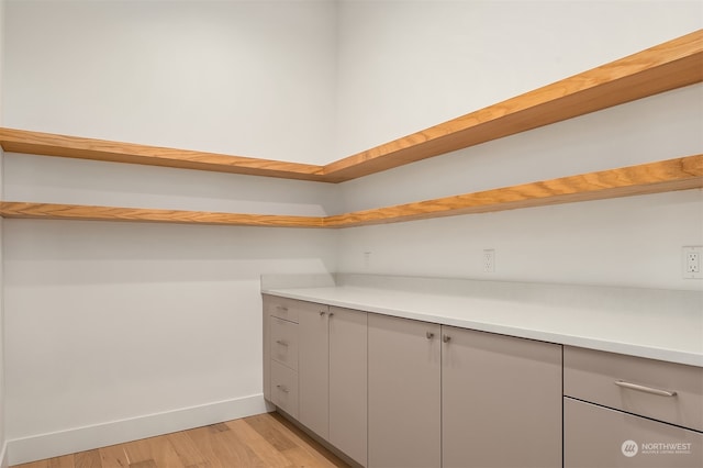 walk in closet featuring light hardwood / wood-style flooring