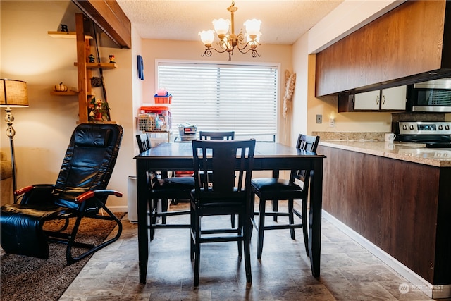 dining area featuring a textured ceiling and an inviting chandelier