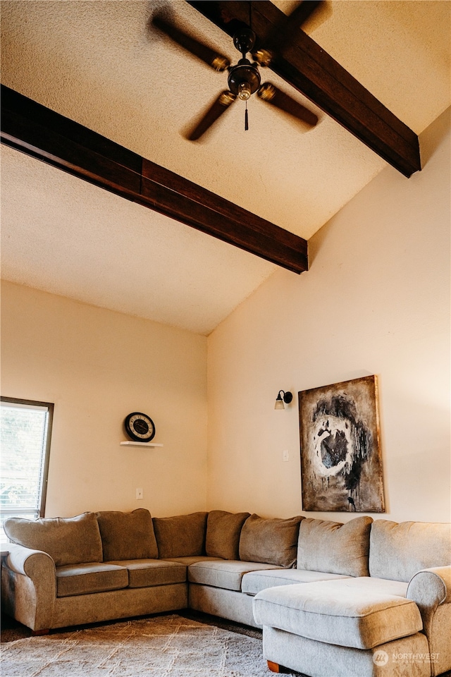 living room featuring vaulted ceiling with beams, ceiling fan, and a textured ceiling